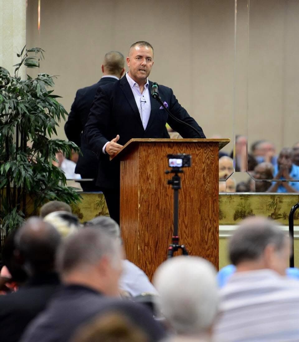 Guy Beveridge addressing a church congregation