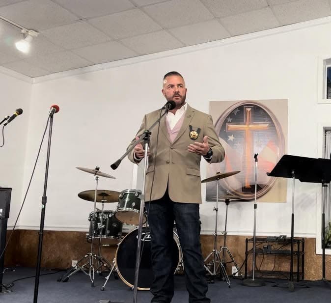 Guy Beveridge speaking at a house of worship